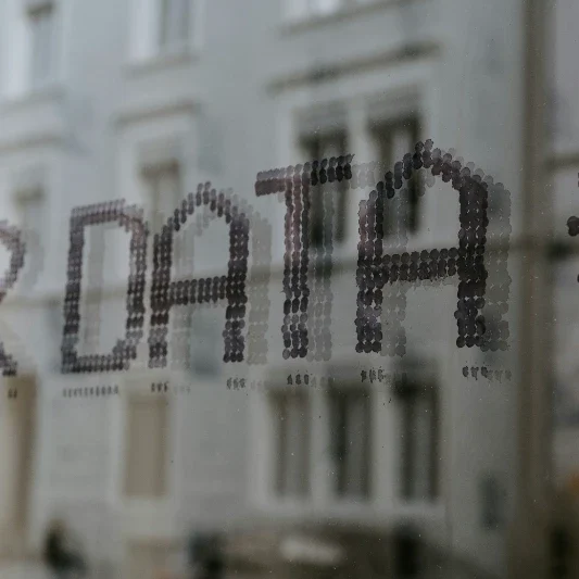 Drone Data Text reading "DATA" displayed on a glass surface with a blurred background.